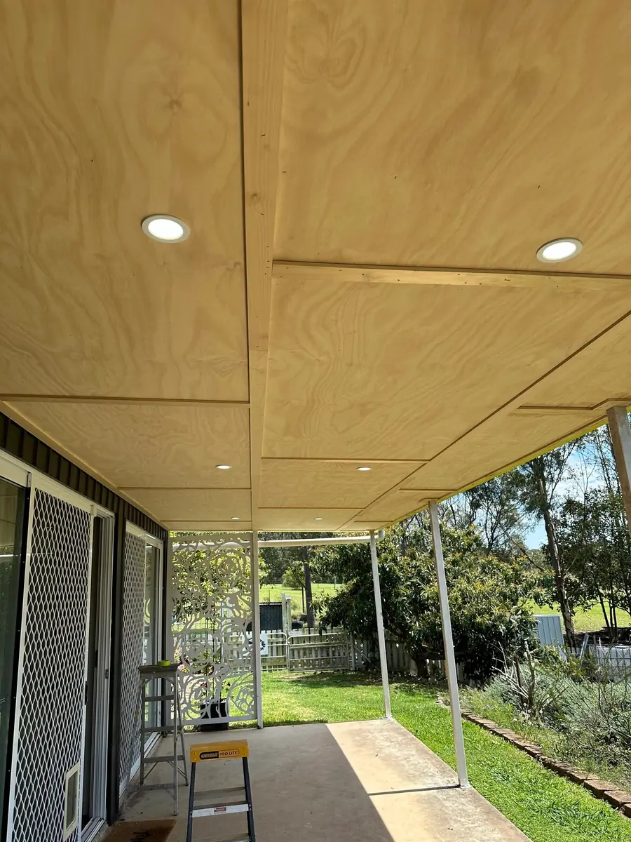 Recessed lights in a timber-lined outdoor ceiling